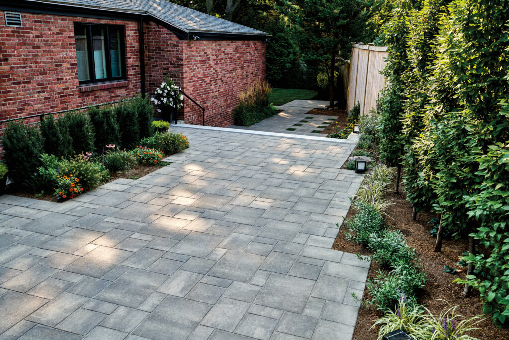 Pavers lead through a backyard garden